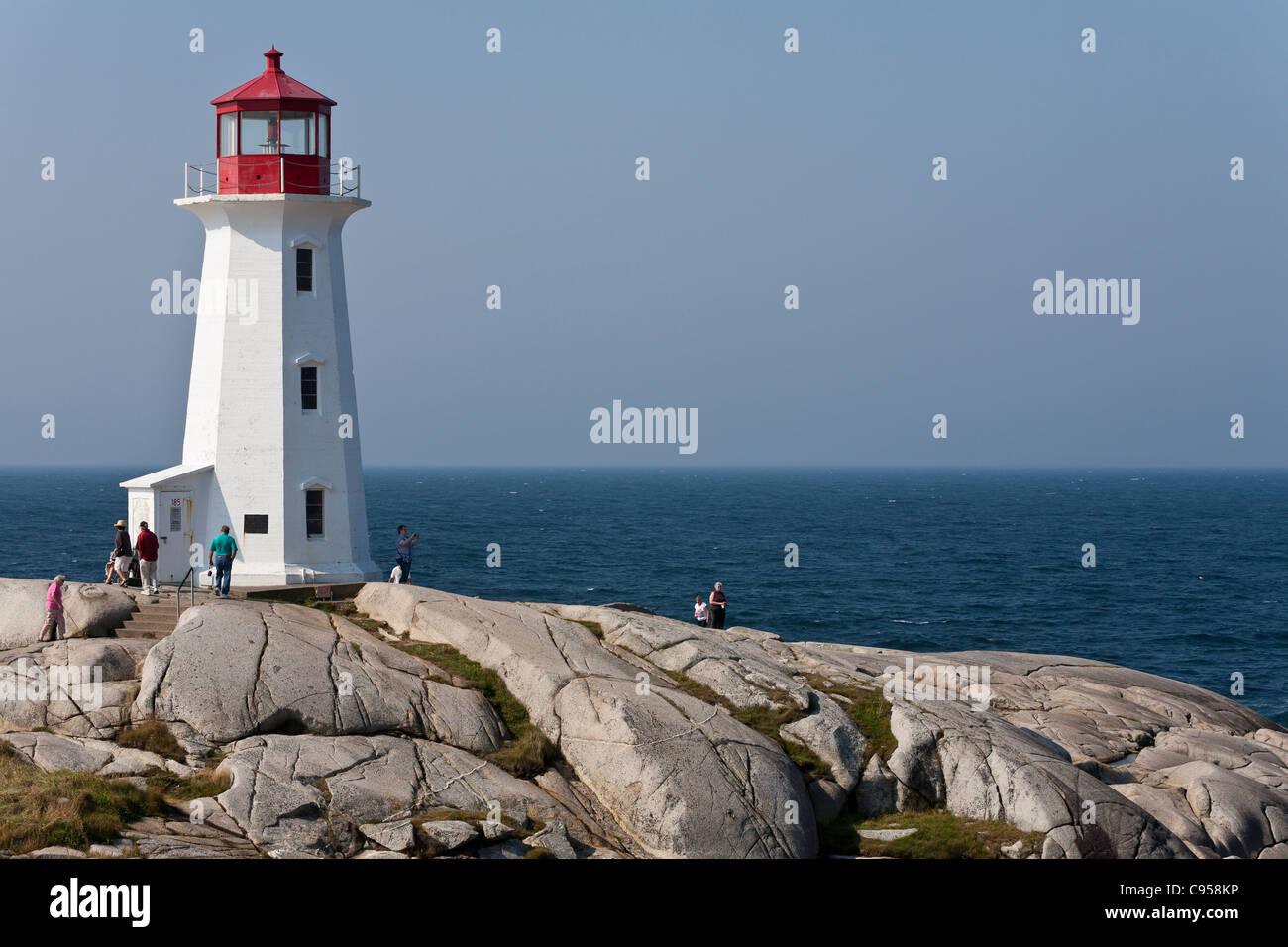 Lighthouse at Peggy's Cove on the sea's edge. This iconic symbol of
