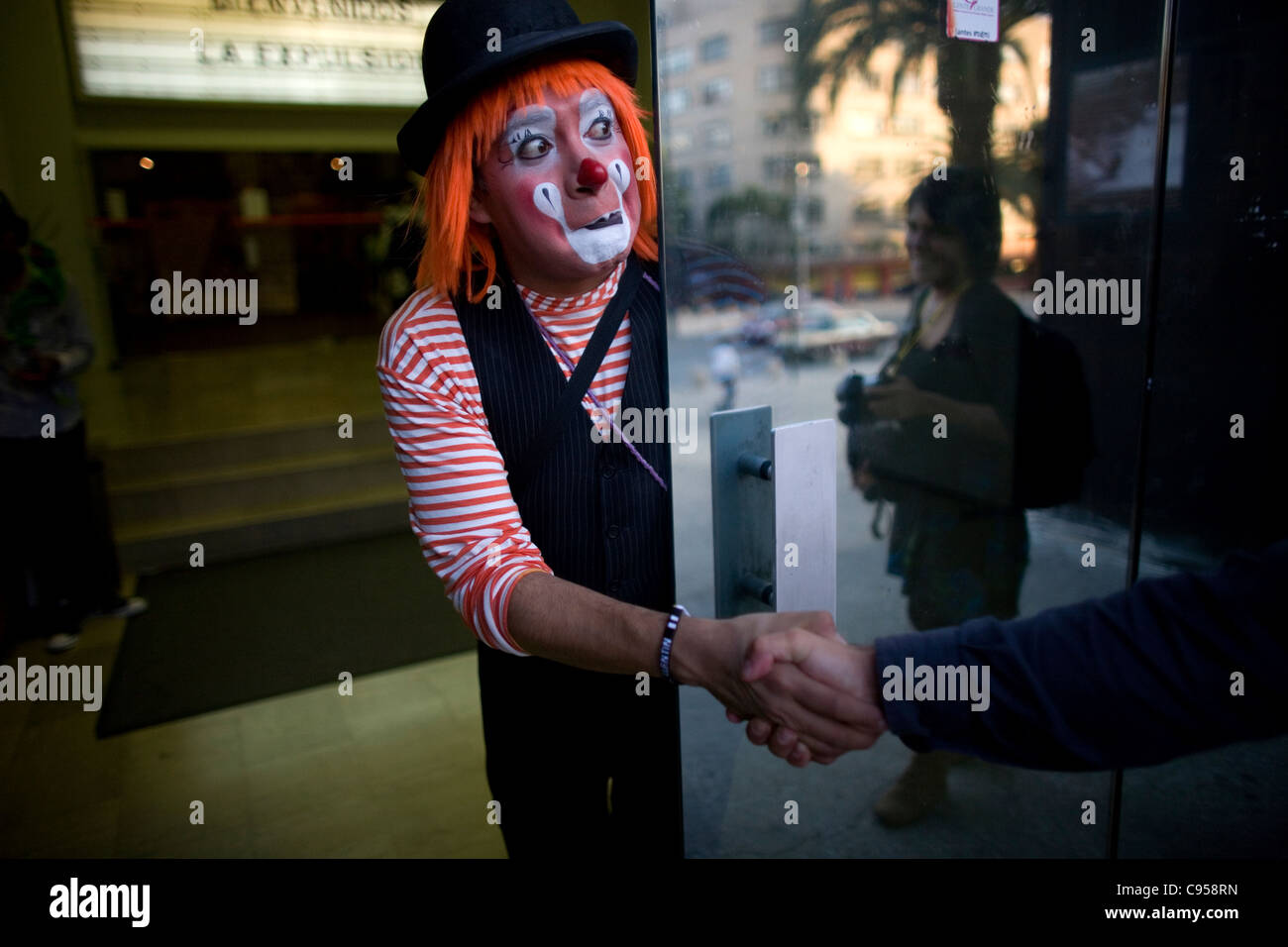 A clown shakes hands with a photographer during the International Clown