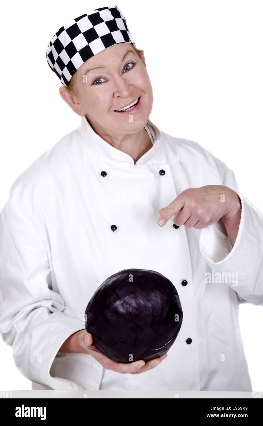 female chef shows with her index finger on a red cabbage Stock Photo