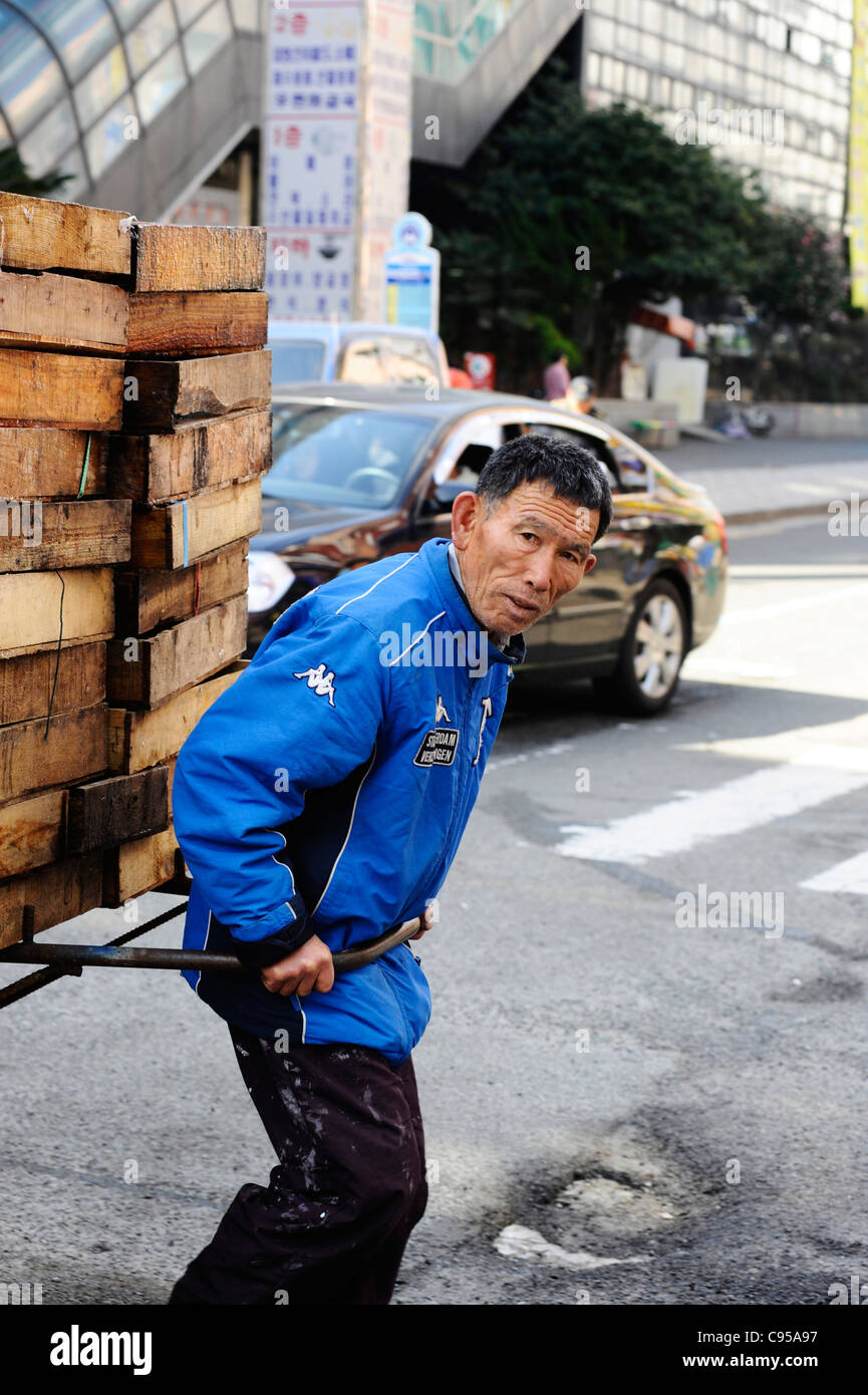 A man pulling a barrow in Busan, South Korea. Stock Photo