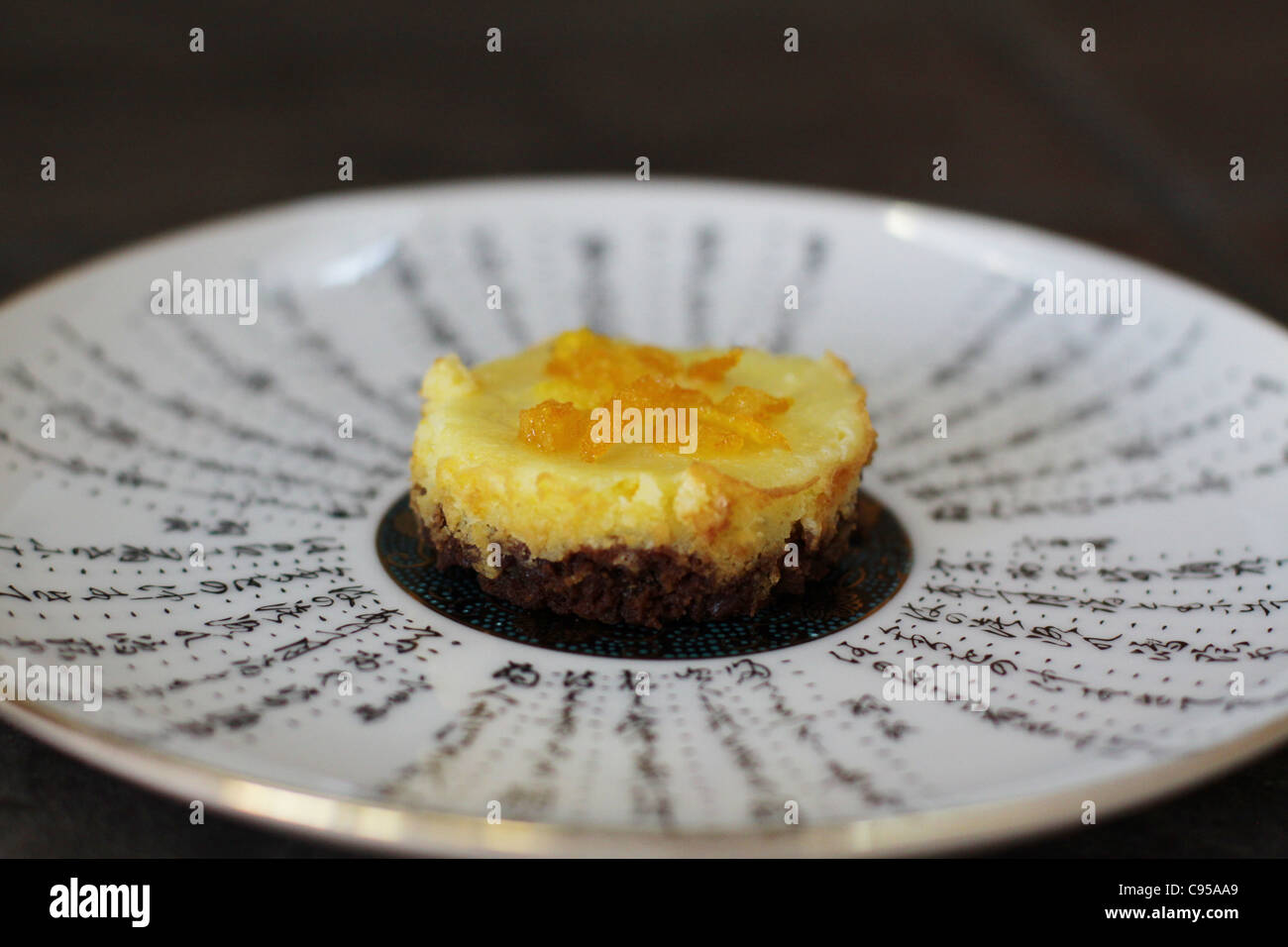 An orange cheesecake with chocolate crust. Stock Photo