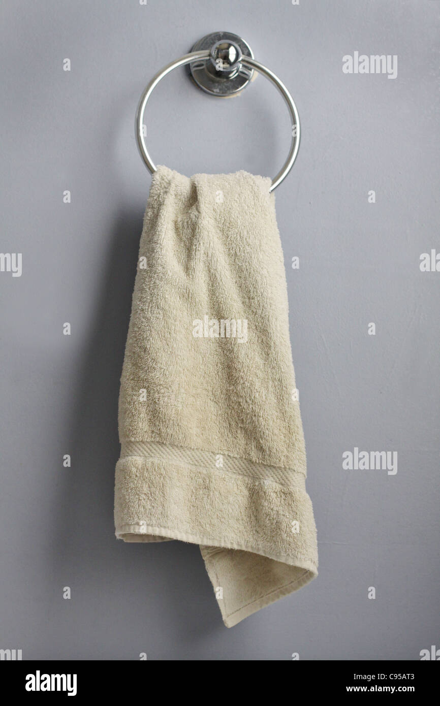 A hand towel hanging from a ring in a bathroom. Stock Photo