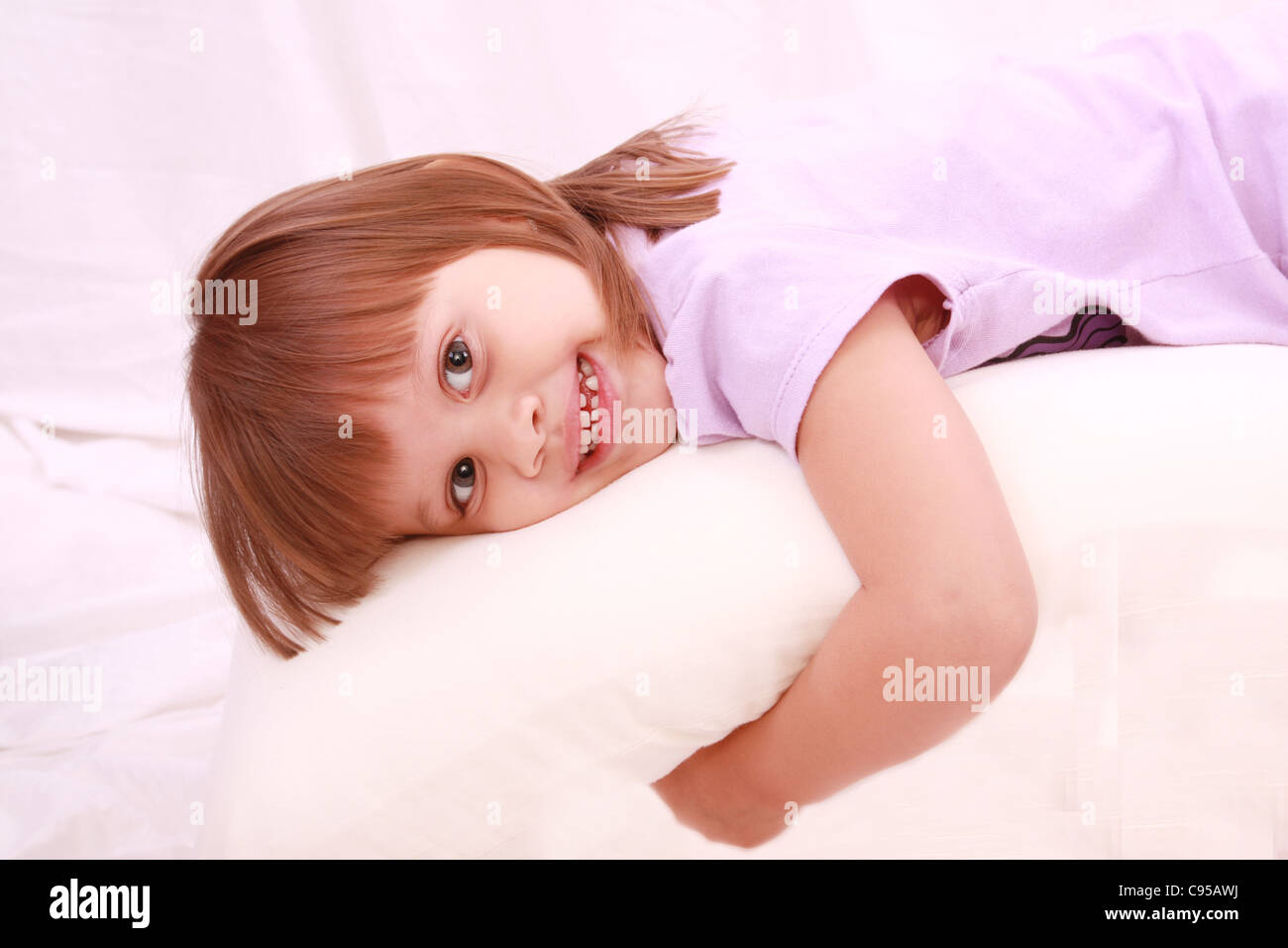 Beautiful little girl lying on bed Stock Photo Alamy
