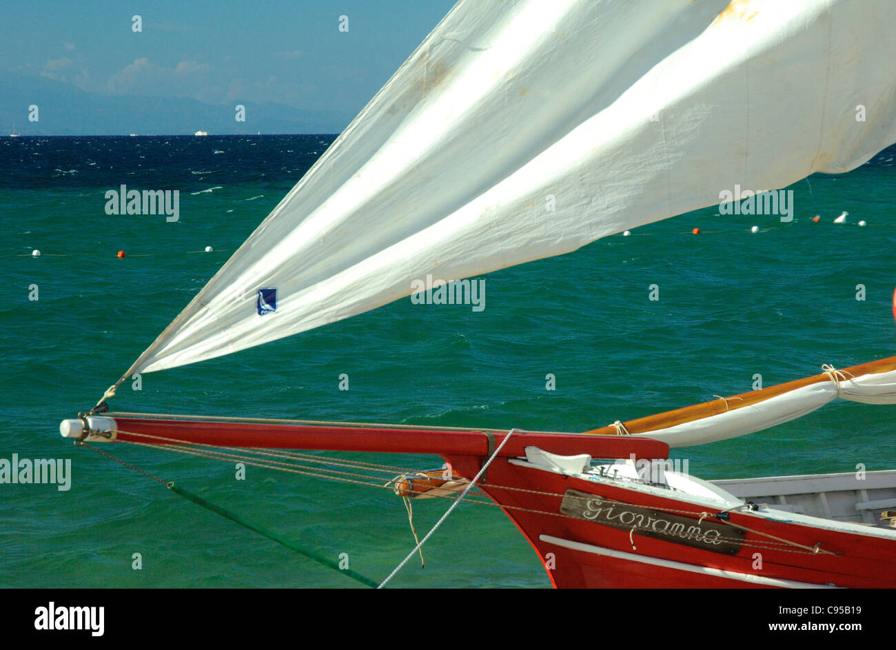 Spinnaker sail of a Latin boat sailing at Porto Pollo beach,Palau,Sardinia Stock Photo