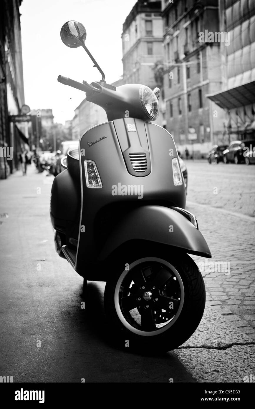 Black and White Photograph of a Matt Black Vespa Scooter in Milan, Stock Photo