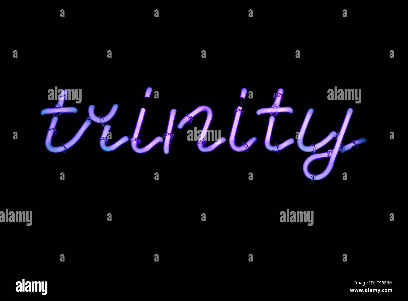 Purple trinity neon sign isolated on black background Stock Photo - Alamy