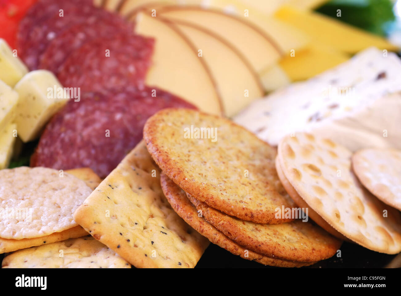 Platter of assorted cheeses, crackers, and salami Stock Photo Alamy