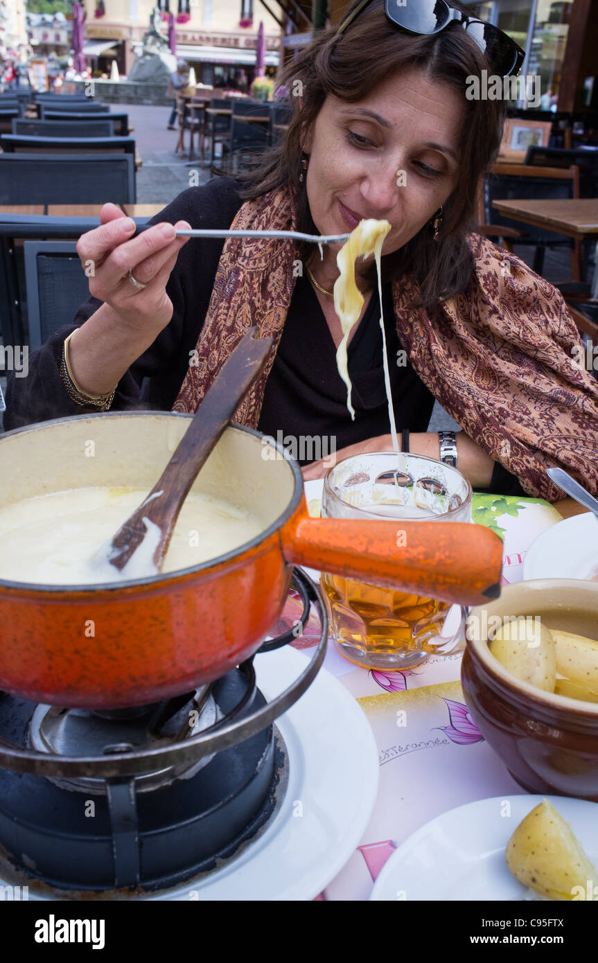 Woman eating fondue. Chamonix, France. 21/09/2011. Stock Photo