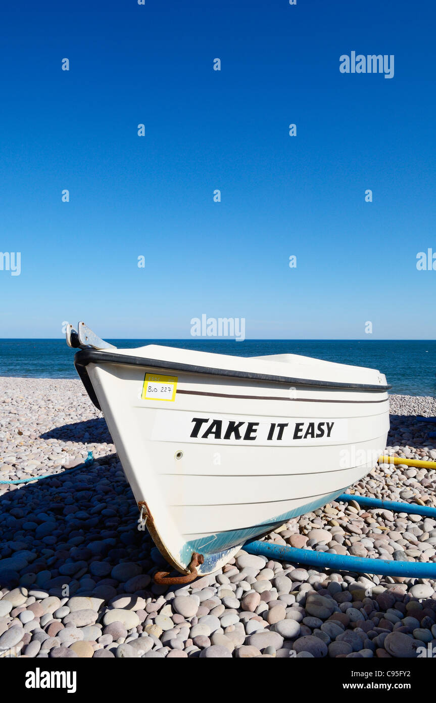Pleasure boat named Take It Easy on the beach at Budleigh Salterton, Devon, England. Stock Photo