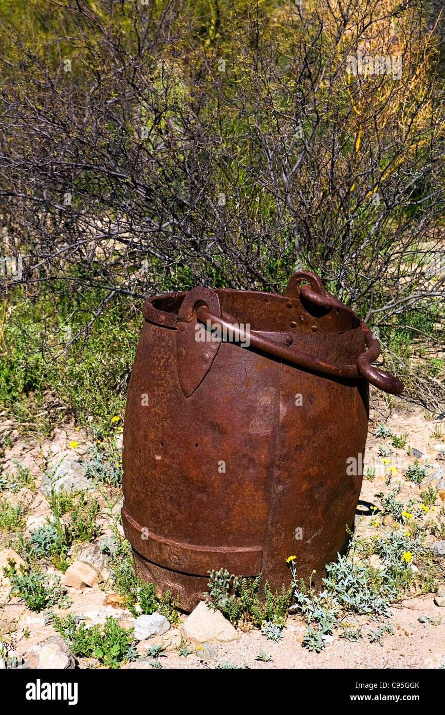 An old rusted bucket with a hoop handle used for mining in Arizona. Stock Photo