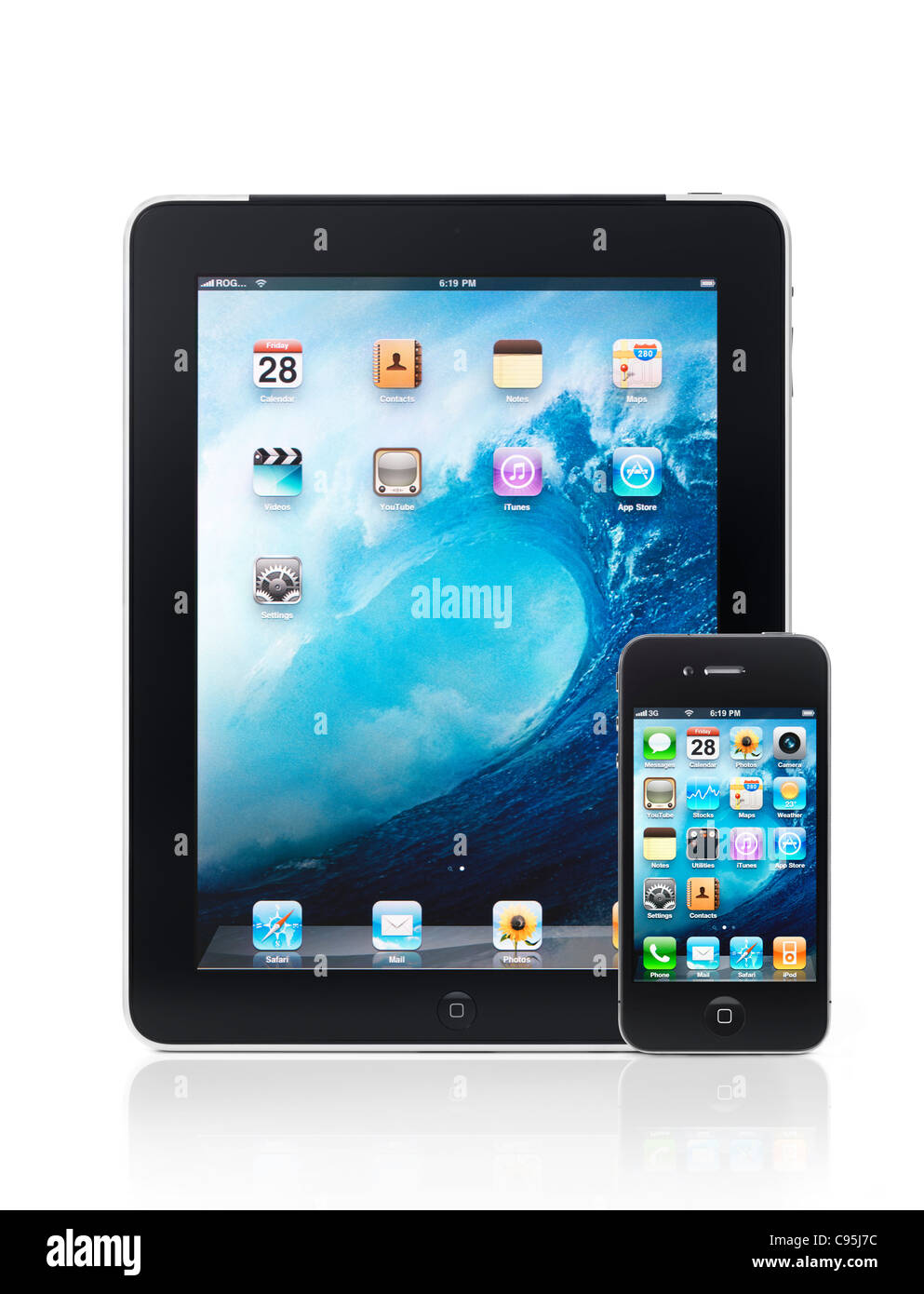 Apple iPad 3G tablet computer and iPhone 4 smartphone with desktop icons on their displays isolated on white background Stock Photo