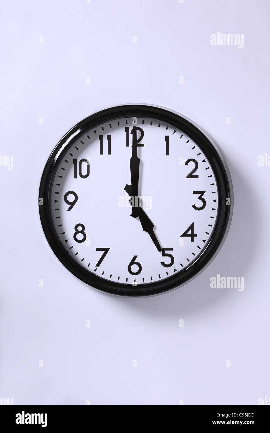 A wall clock at 11 exactly. Stock Photo
