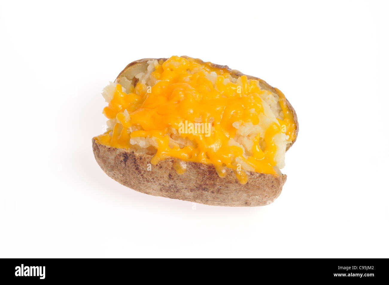 Baked potato topped with orange cheese on white background cutout. Stock Photo