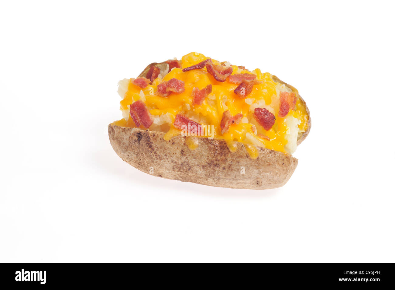 Baked potato topped with melted cheese and bacon bits on white background cutout. Stock Photo