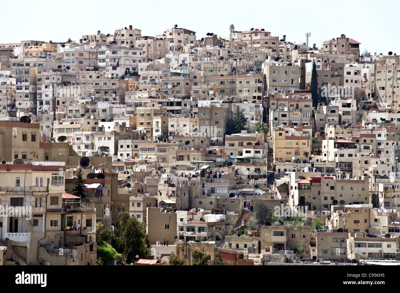 A cityscape of hillside residential low-rise concrete apartments in Jabal al-Weibdeh, near downtown Amman, in the Hashemite Kingdom of Jordan. Stock Photo