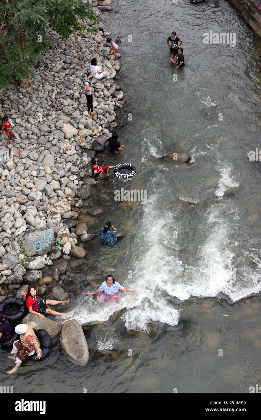 People bathing in the Bohorok River. Bukit Lawang, Sumatra, Indonesia