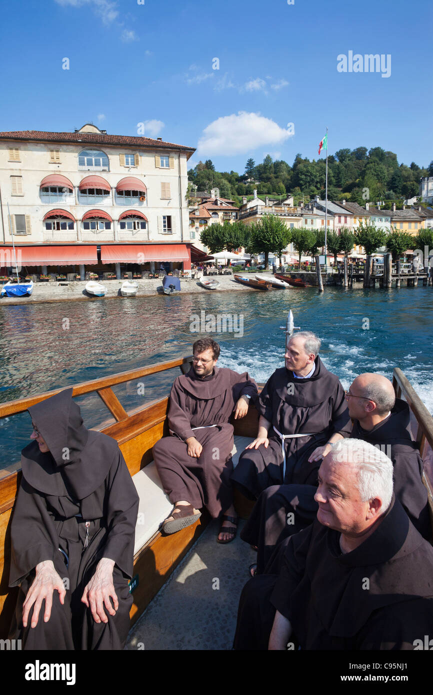 Italy, Piedmont, Lake Orta, Franciscan Monks on Boat to San Giulio Island Stock Photo