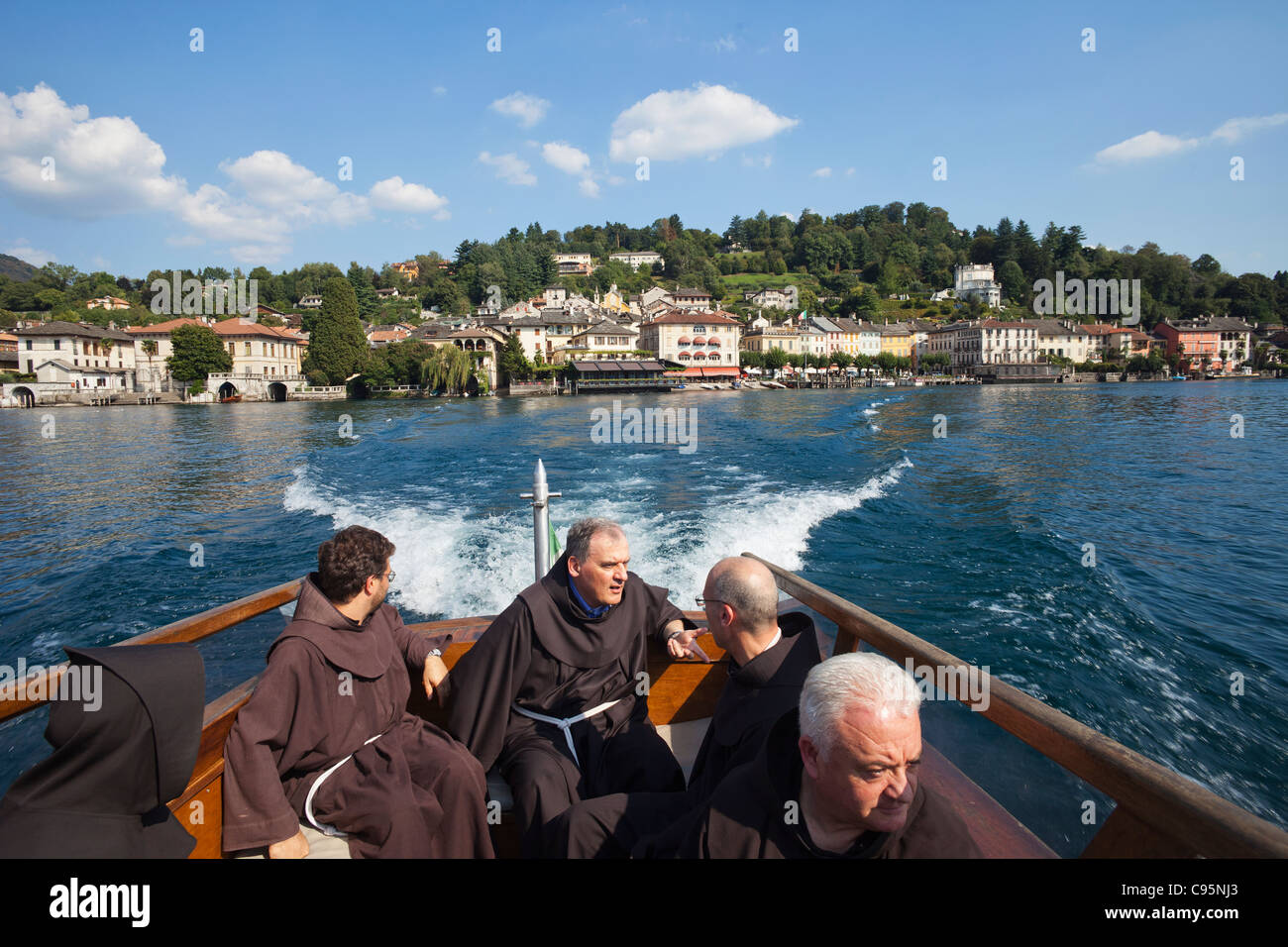 Italy, Piedmont, Lake Orta, Franciscan Monks on Boat to San Giulio Island Stock Photo