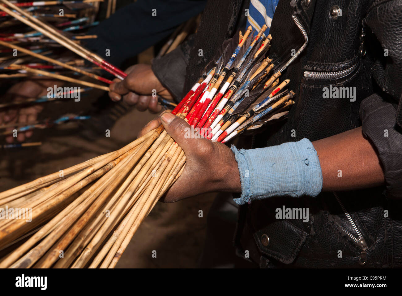 India, Meghalaya, Shillong, Bola archery gambling game, hand holding bunch of colour codedarrows Stock Photo