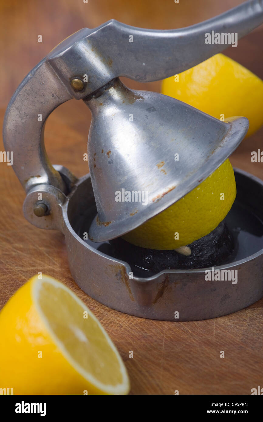 Old lemon squeezer with a lot of lemons Stock Photo Alamy