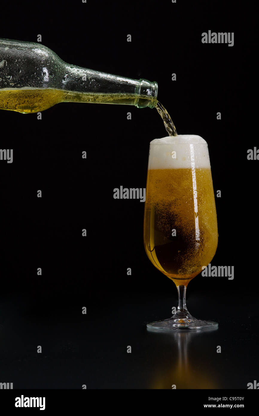 Beer is poured into a glass Stock Photo - Alamy