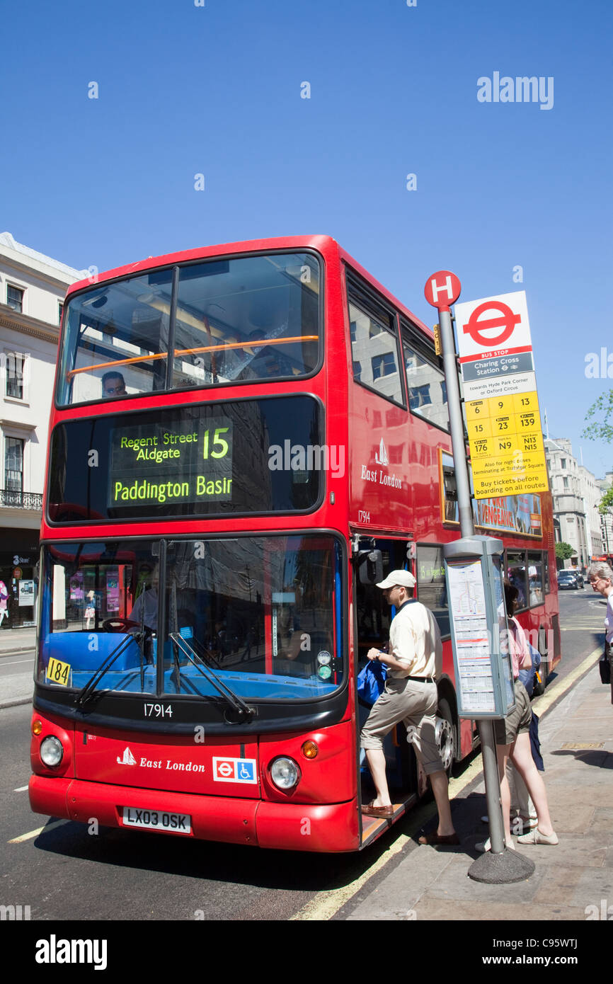 England, London, Passengers Boarding Double Decker Bus Stock Photo
