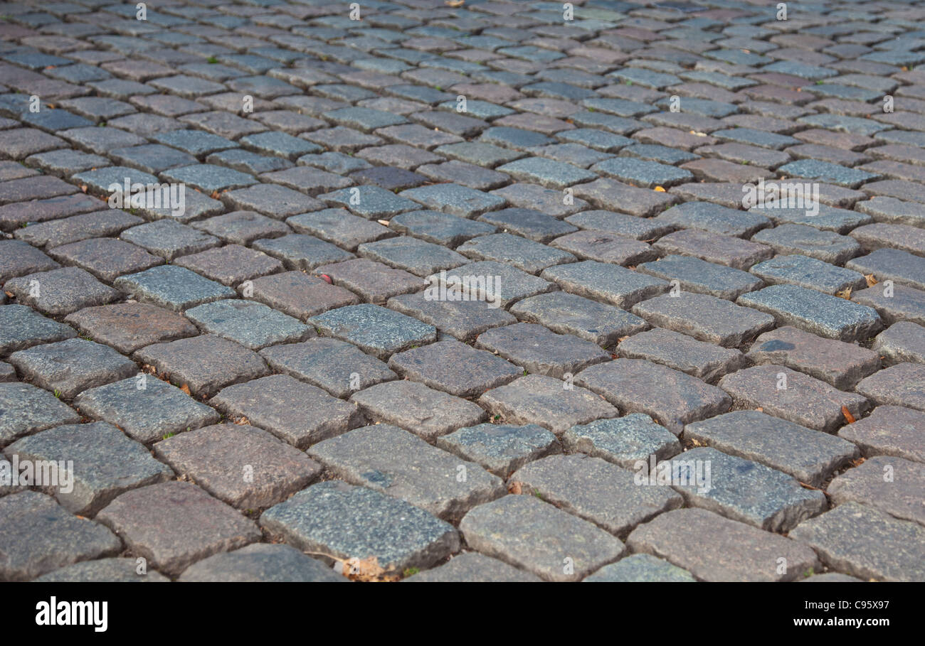 Grey cobbled pavement, background texture. Stock Photo