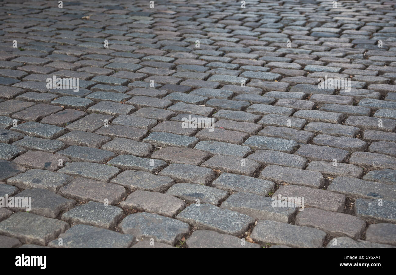 Grey cobbled pavement, background texture. Stock Photo
