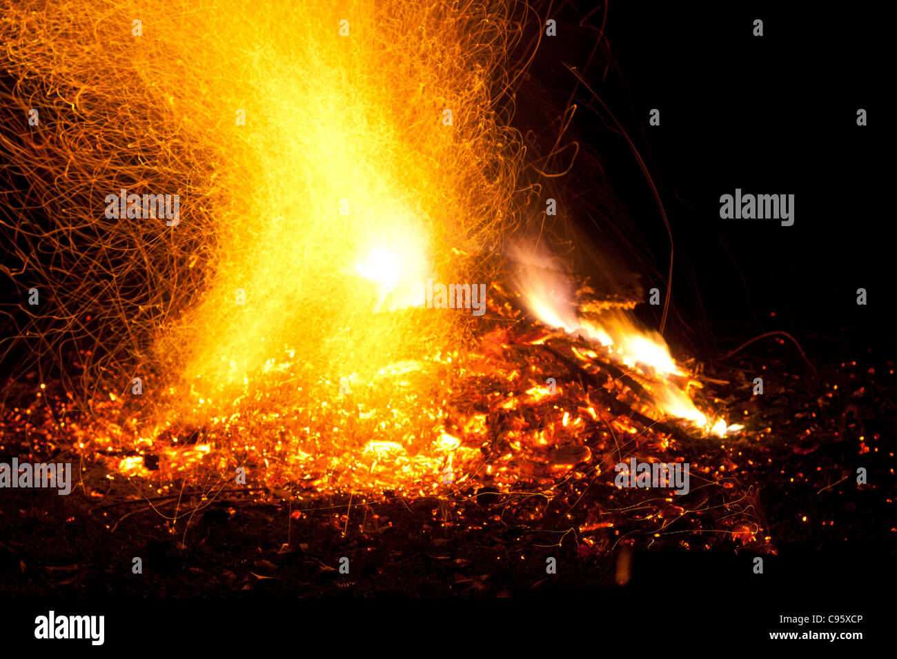 Fire with flames and sparks. Intense orange, yellow glow of bonfire ...