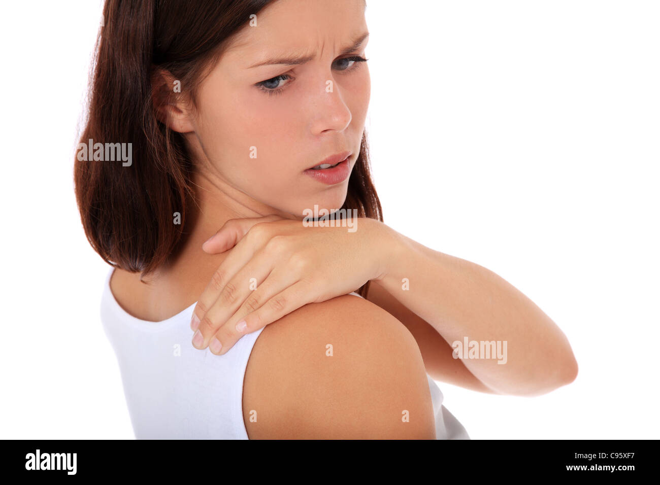Attractive young woman suffers from neck pain. All on white background. Stock Photo