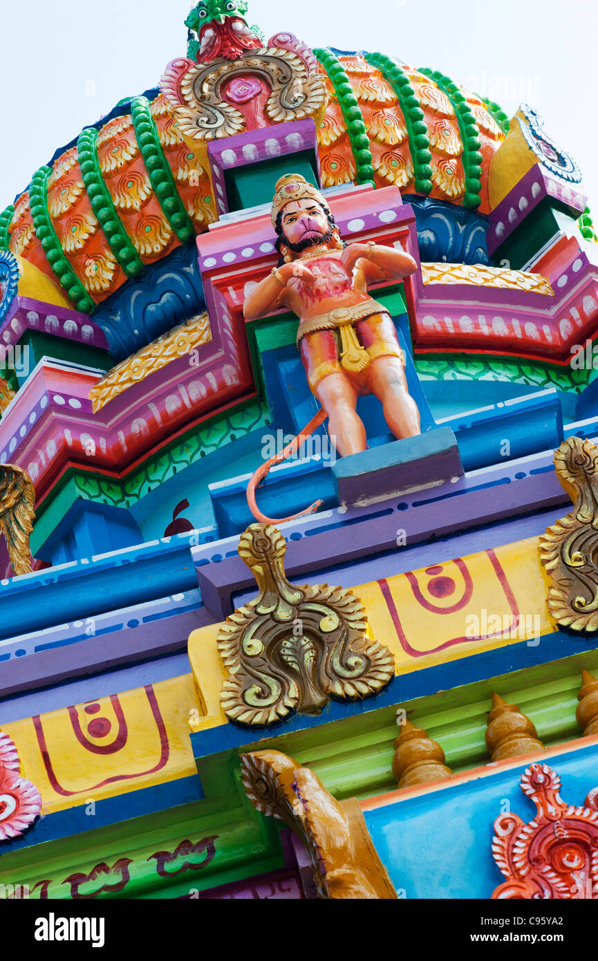 Colourful Hindu temple top with a hanuman statue. Andhra Pradesh, India Stock Photo