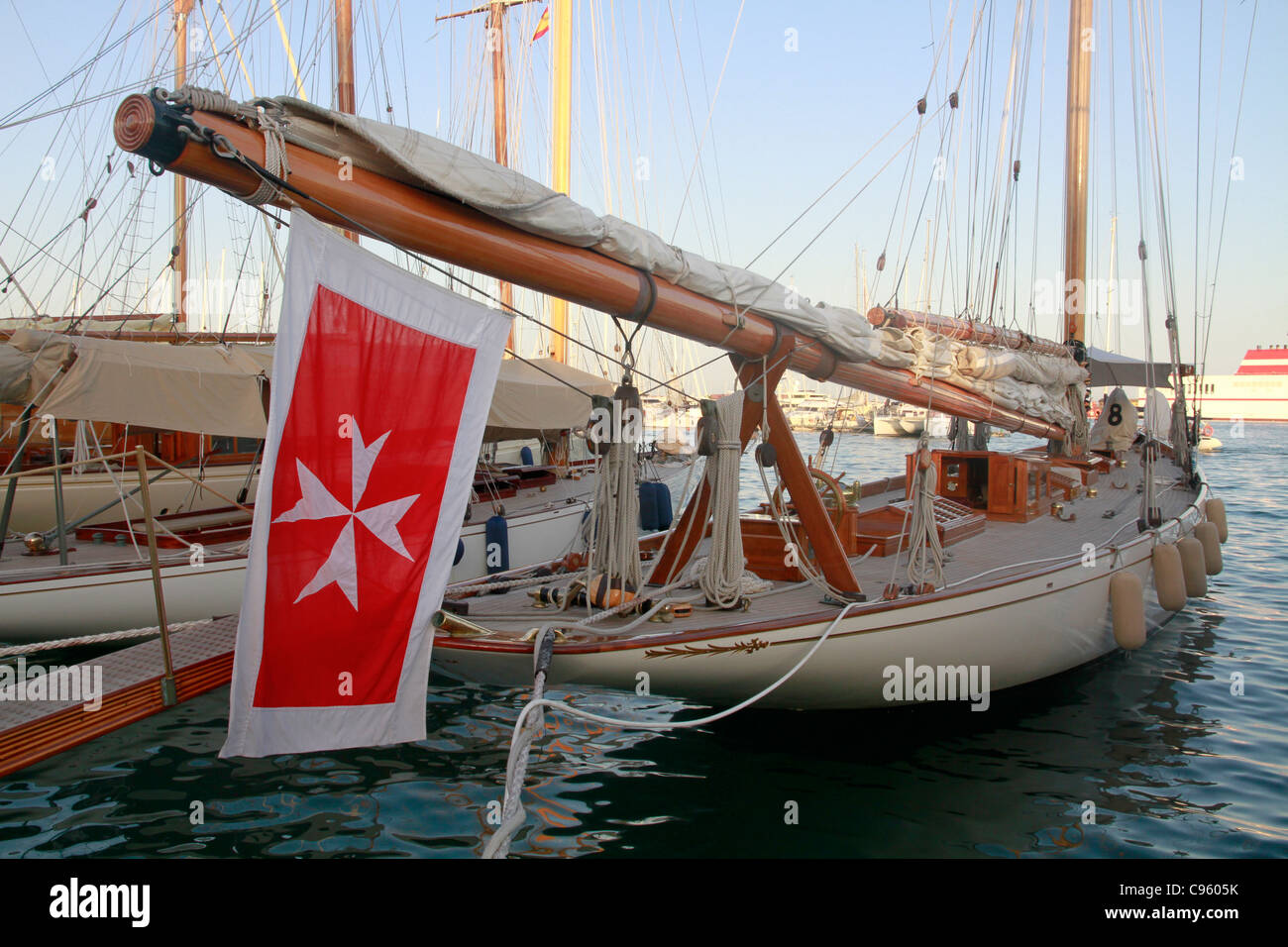 Classic yacht sail boat, boom and flag, moored in port of Palma de