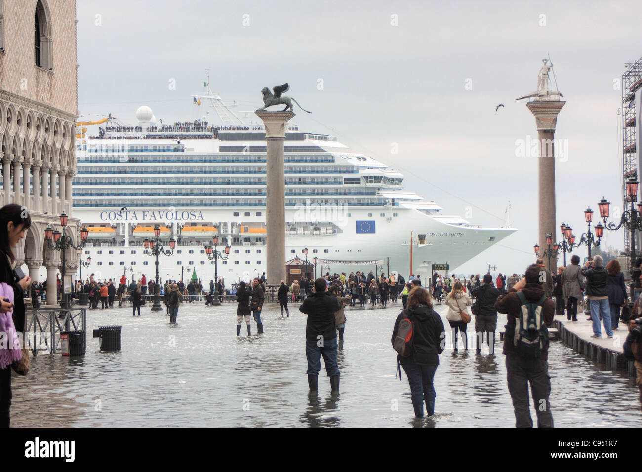 Cruise ship 'Costa Favolosa'  passing the St. Mark's Basin (Bacino di San Marco) during acqua alta, Venice Stock Photo