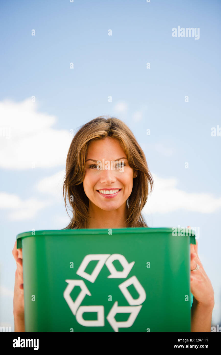 USA, New Jersey, Jersey City, Woman holding recycling bin Stock Photo Alamy