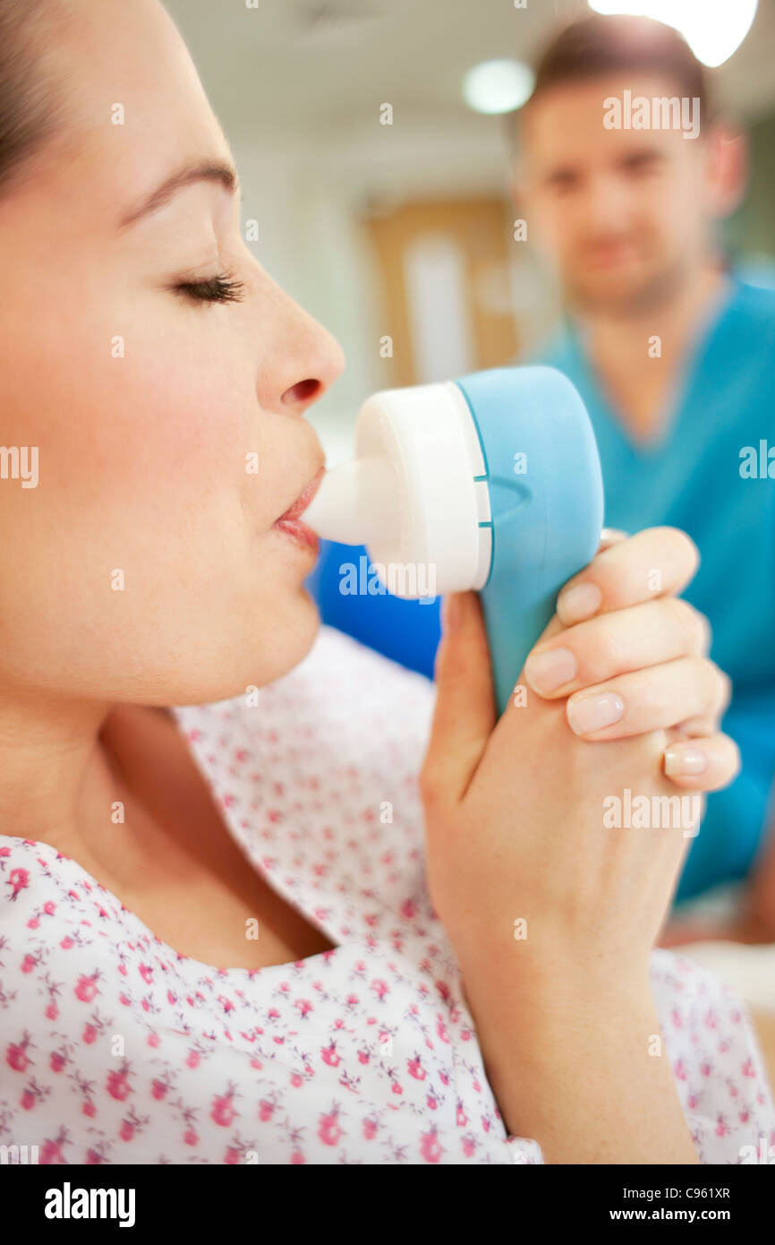 Childbirth. Pregnant woman taking gas and air during childbirth Stock