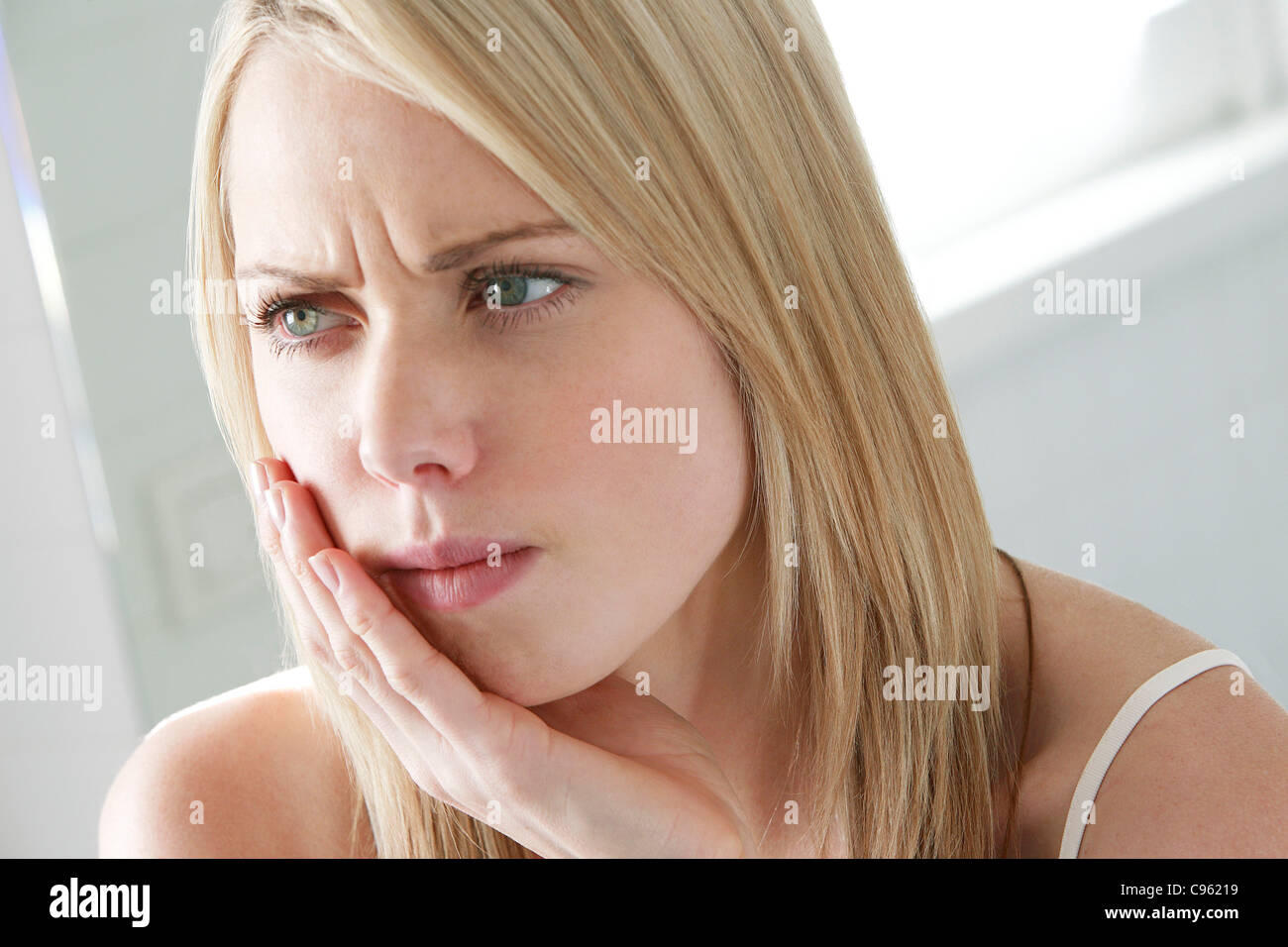 Toothache. Woman holding her jaw Stock Photo Alamy