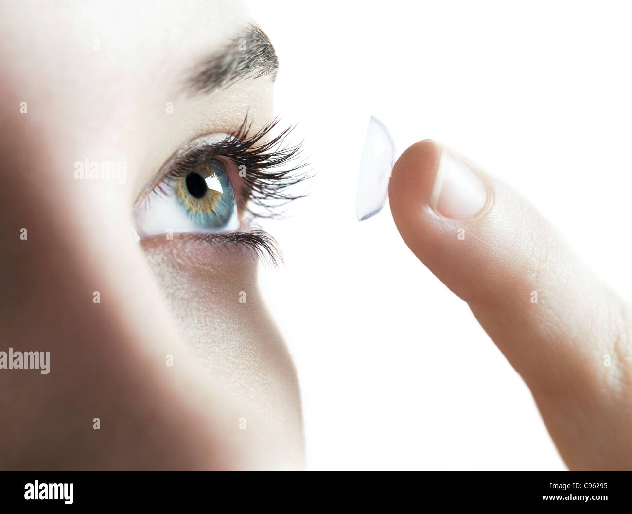 Contact lens use. Woman putting in a contact lens. Stock Photo