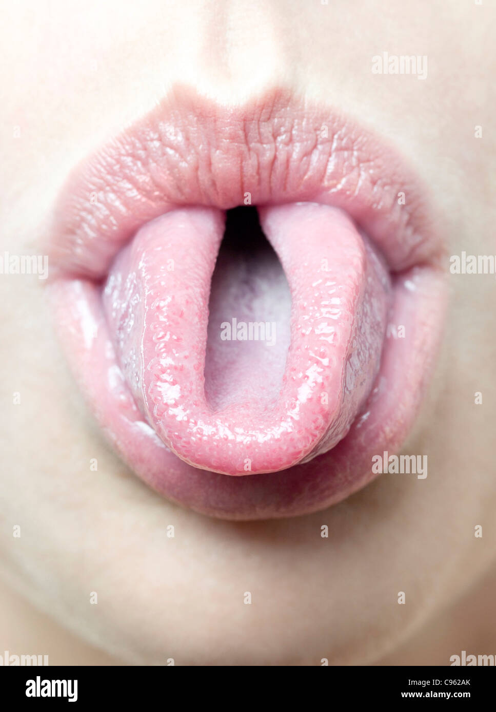 Woman rolling her tongue Stock Photo - Alamy