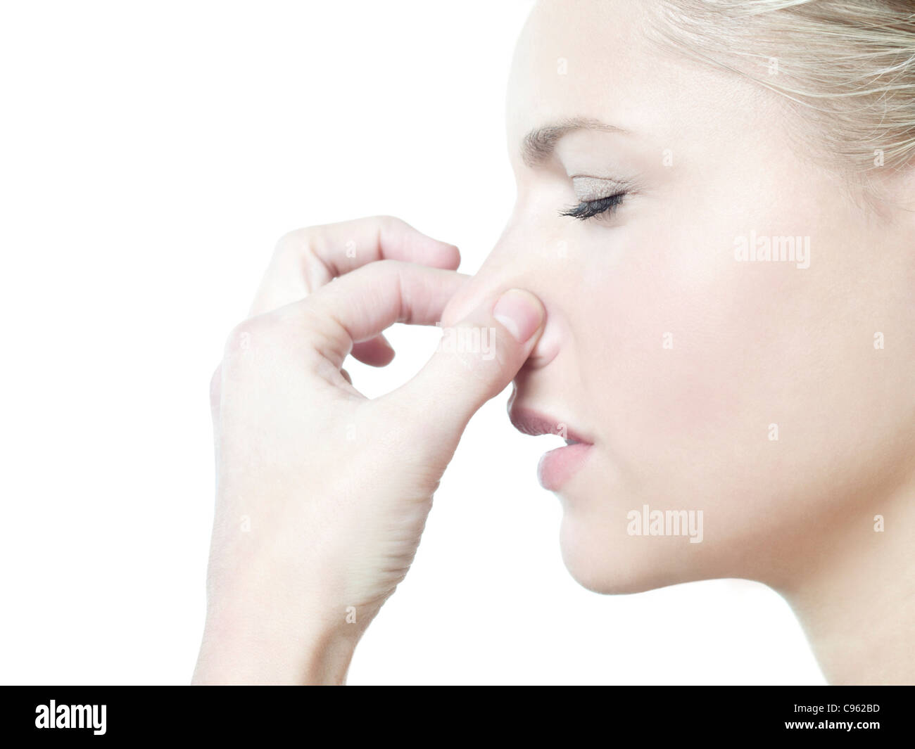 Woman holding her nose. Stock Photo