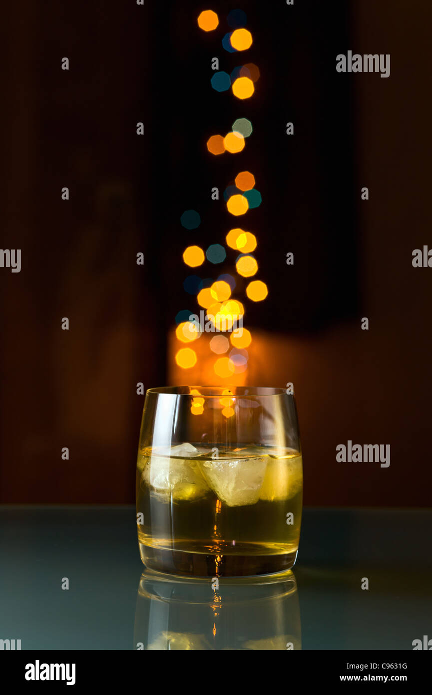 whisky with ice on a glass table. Stock Photo