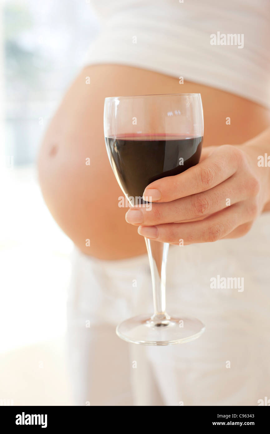 Pregnant woman with a glass of wine Stock Photo Alamy