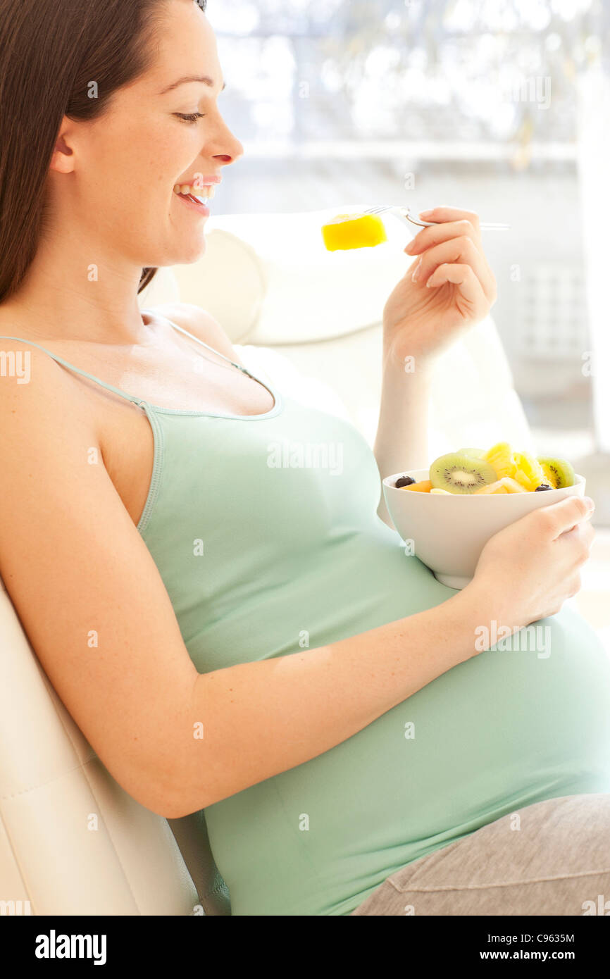 Pregnant woman eating a fruit salad Stock Photo Alamy
