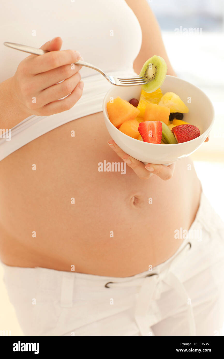 Pregnant woman eating a fruit salad Stock Photo Alamy