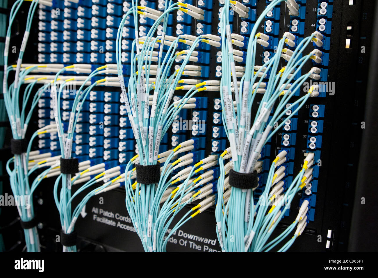 Bundles of network system cables connected to large computer system at