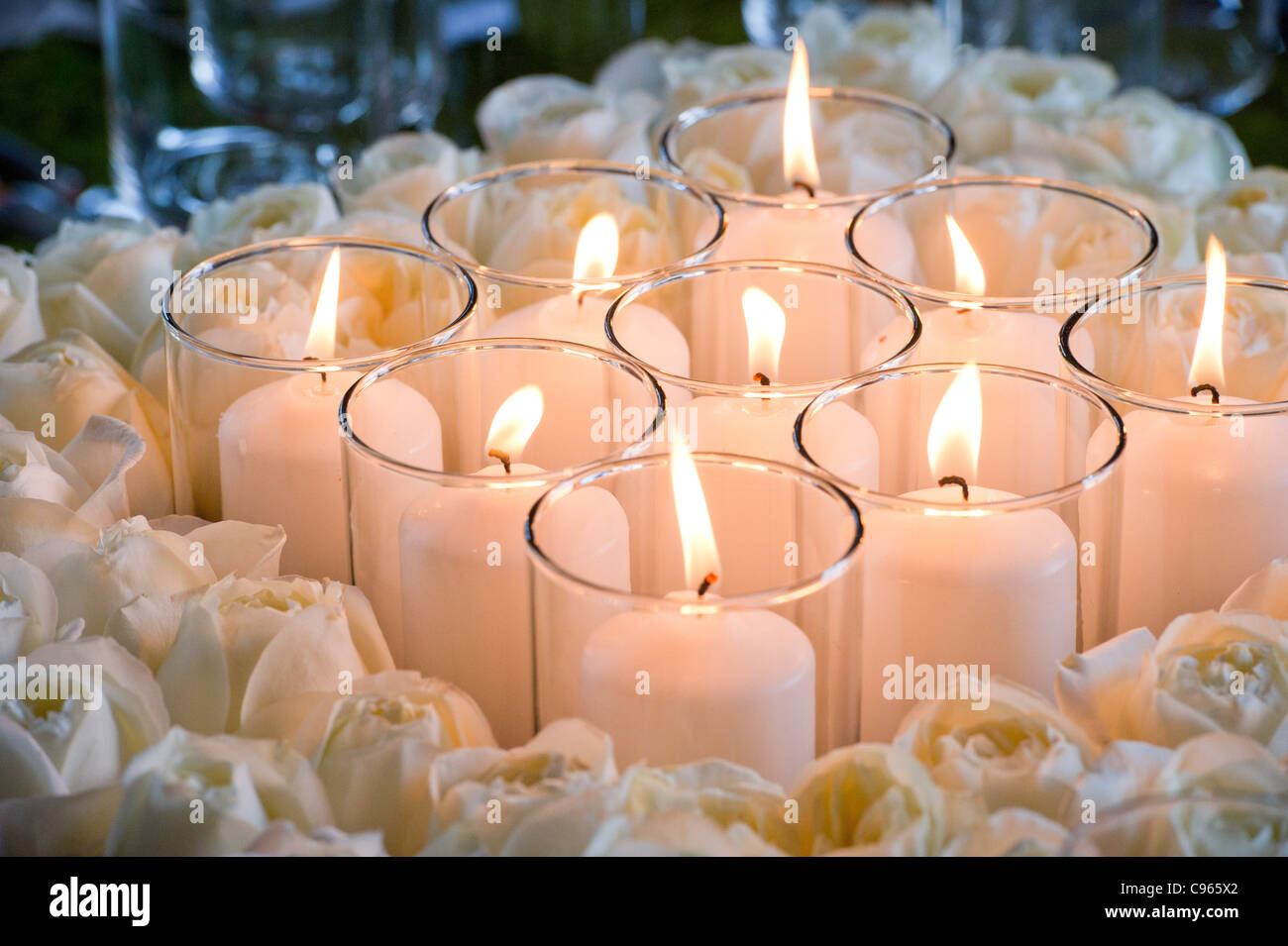 Group of candles surrounding by wreath of roses  Stock Photo