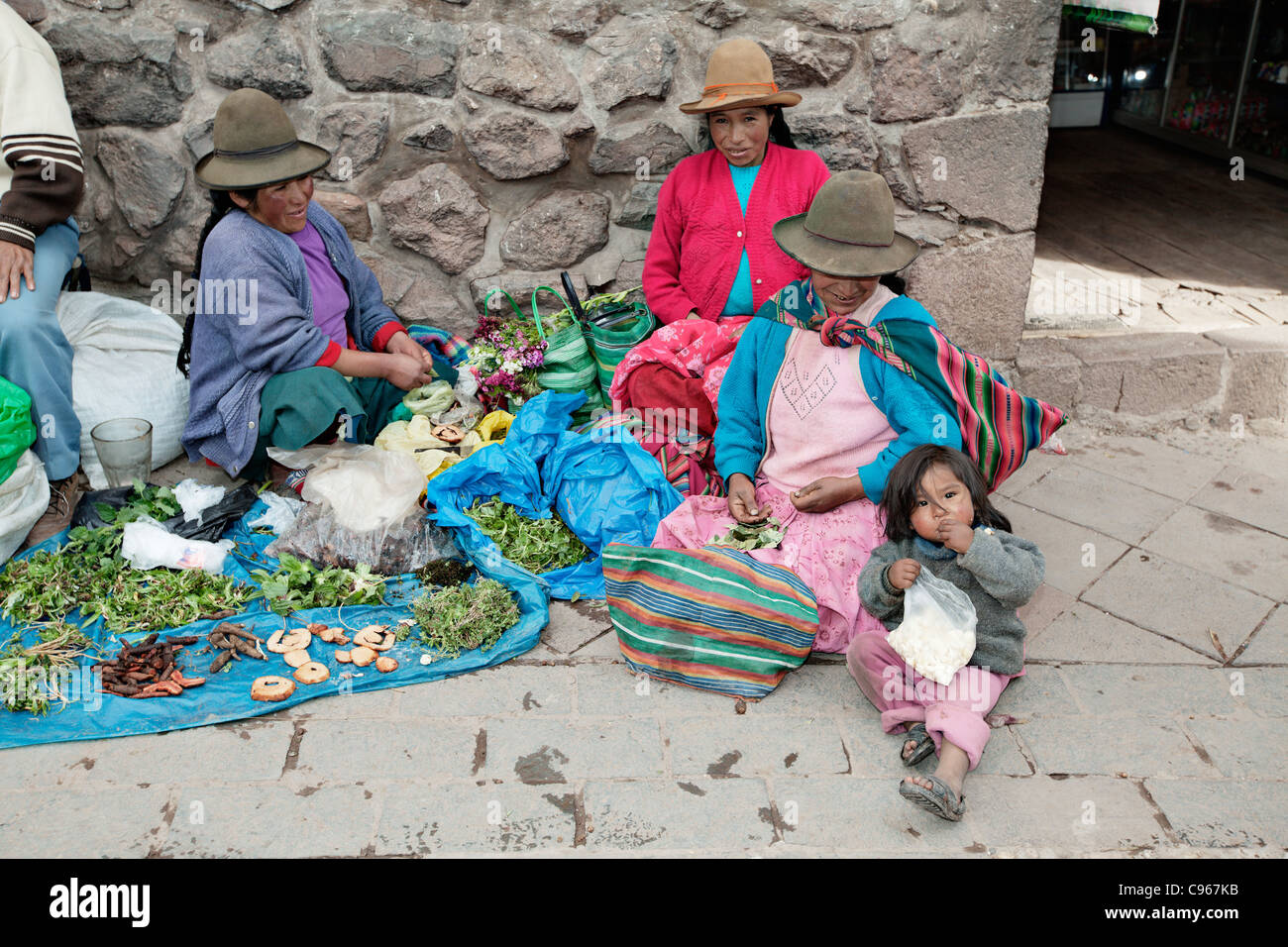 Indigenous women selling vegetables at Pisaq (Pisac) market, Andes mountains, Peru. Stock Photo