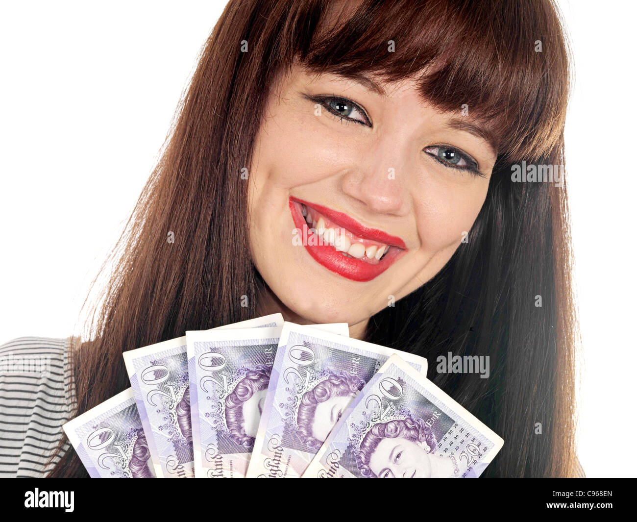 Happy Successful Young Woman Holding British Twenty Pound Notes Cash Isolated Against A White Background Stock Photo