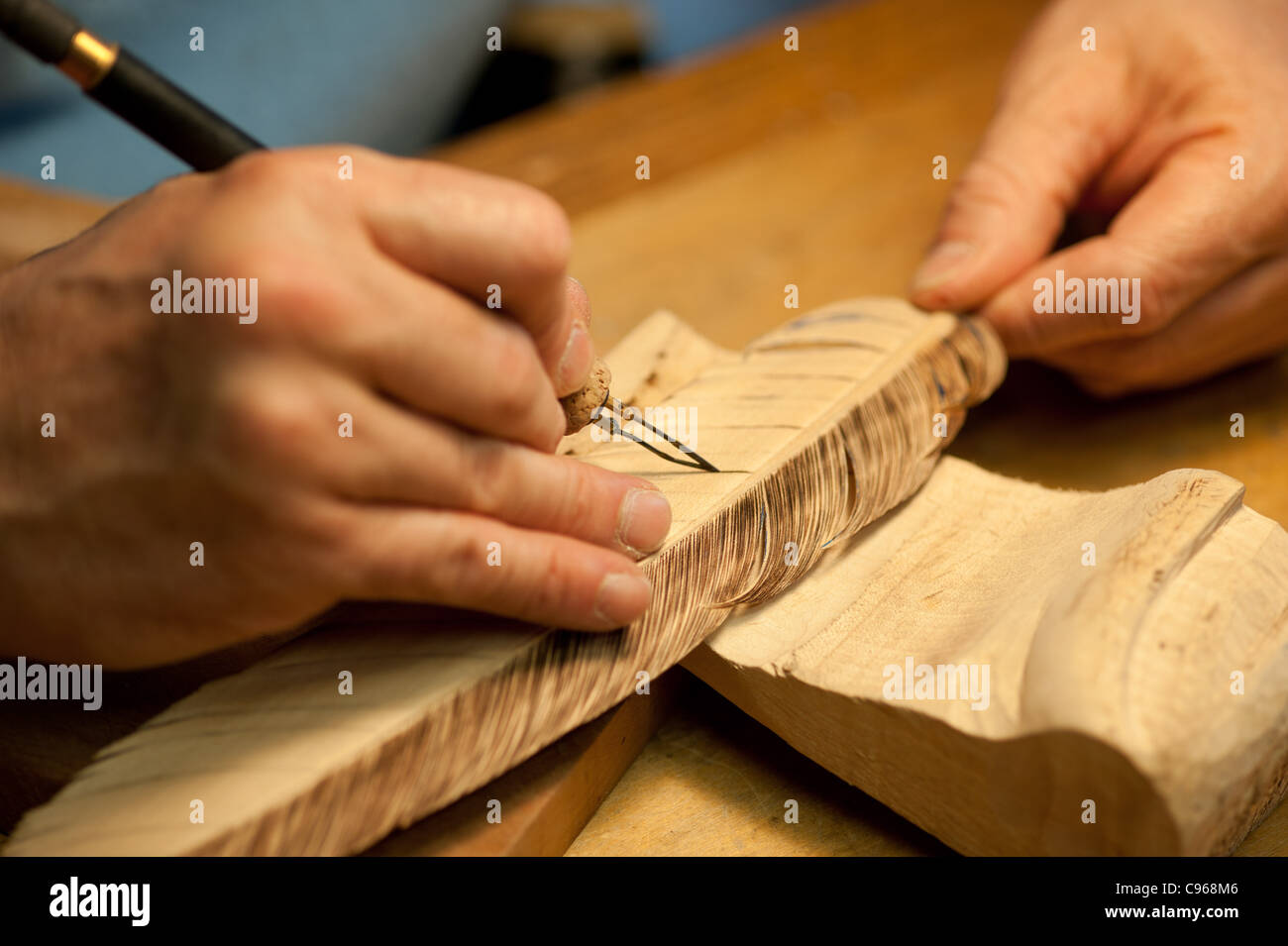 Man carving a bird decoy in his woodworking shop. Stock Photo