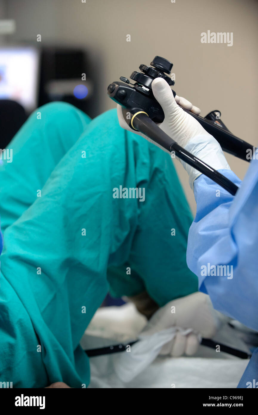 Doctor operating an endoscope to perform a colonoscopy examination