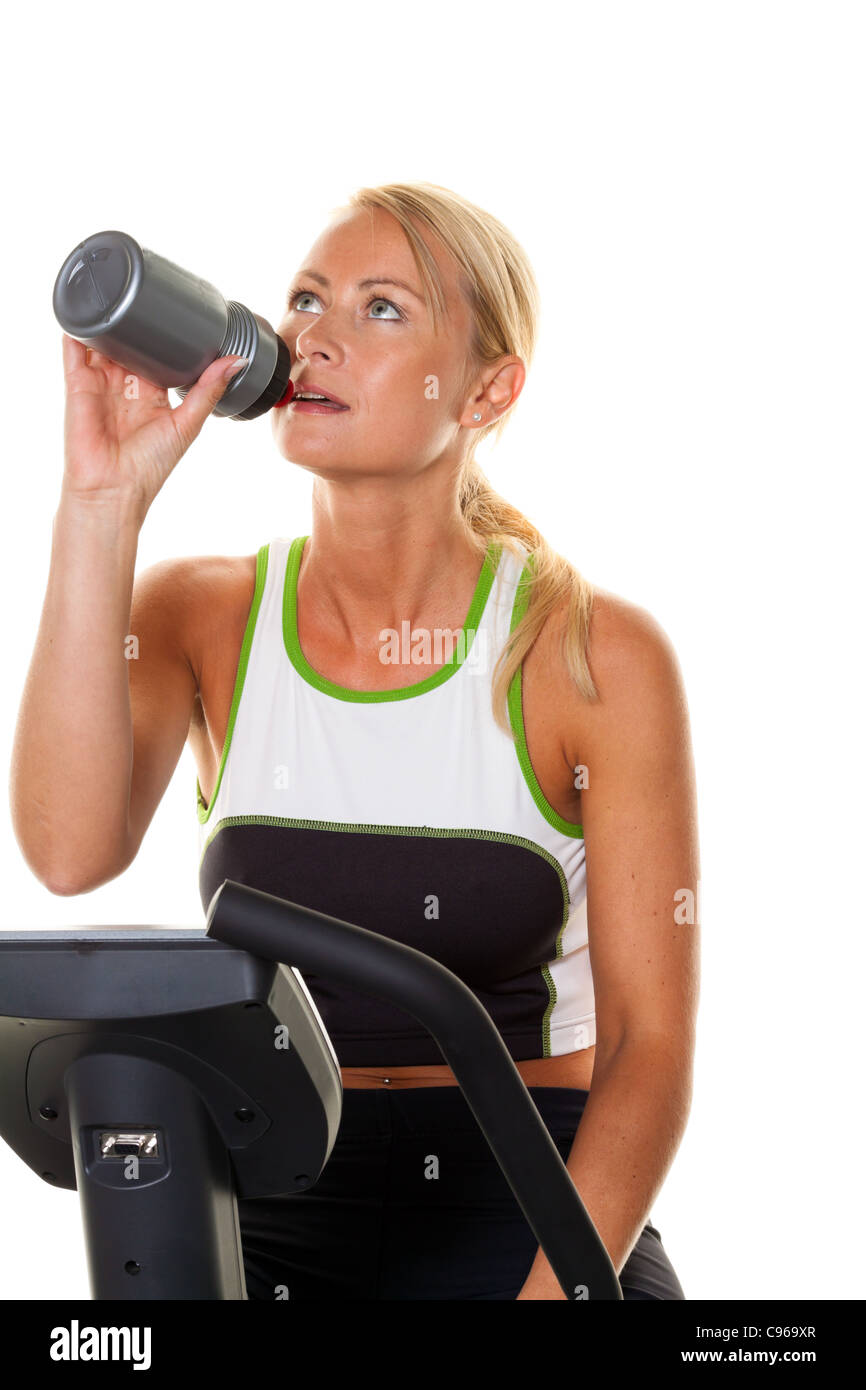 A young woman exercising for endurance on the ergometer. Stock Photo